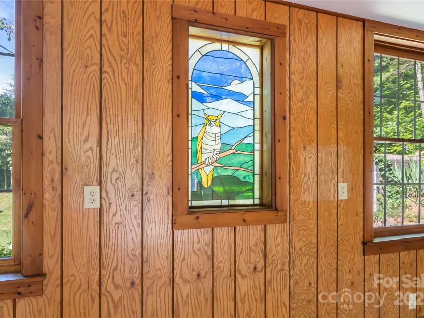 17 Park Road, Asheville, NC 28803.  MLS# CAR4278105, YatesRealty ID 27028. This stain-glass window is a highlight of this huge bonus room.