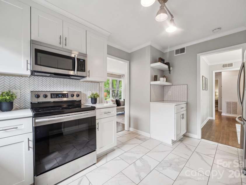 513 Inwood Drive, Charlotte, NC 28209.  MLS# CAR4251489, YatesRealty ID 27032. The bright, updated kitchen comes complete with quartz countertops, a coffee bar, and SS appliances.