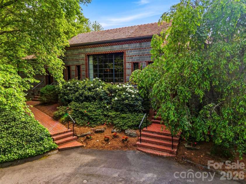 24 Kimberly Avenue, Asheville, NC 28804.  MLS# CAR4373519, YatesRealty ID 27050. Designed between 1949 and 1950, Ellington utilized innovative original cinder block construction to create a home that felt like a timeless fortress
