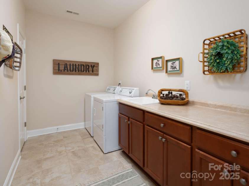 14914 Dewpoint Place, Huntersville, NC 28078.  MLS# CAR4279093, YatesRealty ID 27066. Huge laundry room with tons of storage and large folding counter.  Storage closet as well!