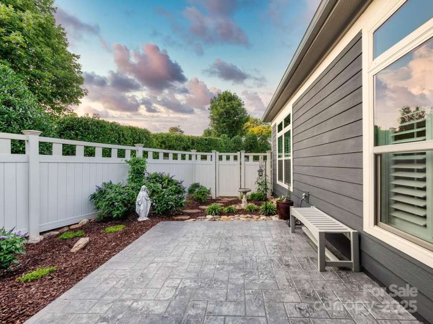 14914 Dewpoint Place, Huntersville, NC 28078.  MLS# CAR4279093, YatesRealty ID 27066. Privacy fence is surrounded by mature, lush landscaping.