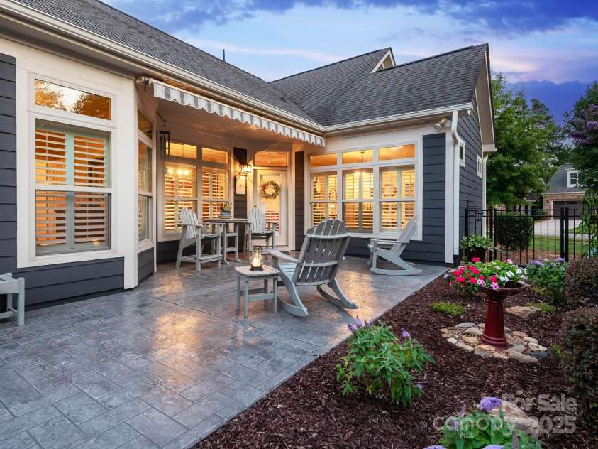 14914 Dewpoint Place, Huntersville, NC 28078.  MLS# CAR4279093, YatesRealty ID 27066. Private, fully fenced courtyard with stamped concrete patio and motorized awning.  Part of the patio is covered.
