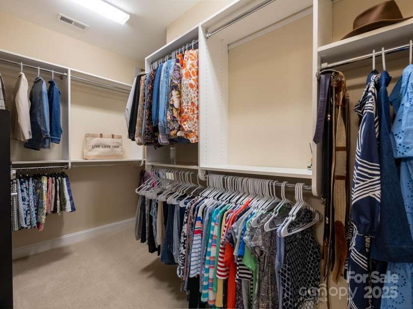 14914 Dewpoint Place, Huntersville, NC 28078.  MLS# CAR4279093, YatesRealty ID 27066. The Palazzo model offers a large primary closet which wraps around to the right.  Upgraded custom closet - no wire shelving.