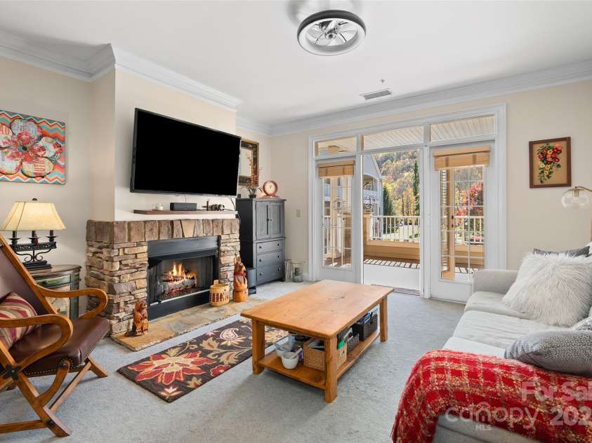 91 Glenview Lane, Maggie Valley, NC 28751.  MLS# CAR4312571, YatesRealty ID 2707. Living room out to expansive deck