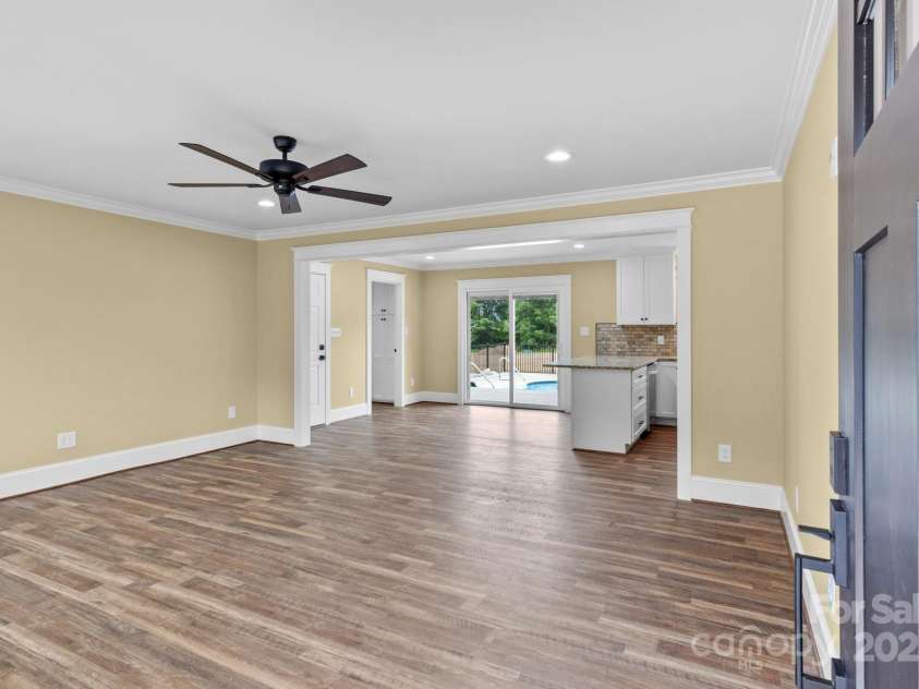 893 Chief Thomas Road, Harmony, NC 28634.  MLS# CAR4278148, YatesRealty ID 27073. Bright and open living space with luxury vinyl plank flooring, crown molding, recessed lighting, and large front windows that let the natural light pour in.