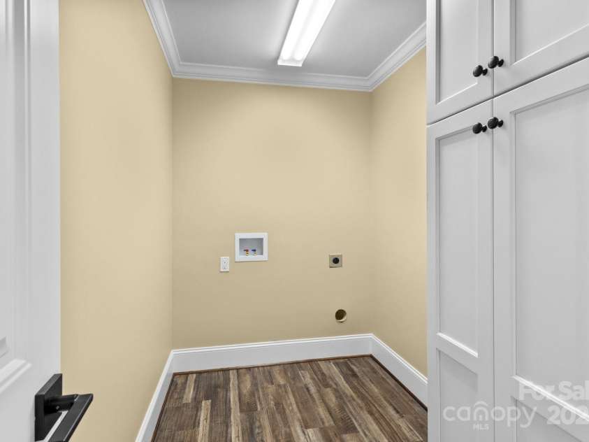 893 Chief Thomas Road, Harmony, NC 28634.  MLS# CAR4278148, YatesRealty ID 27073. Dedicated laundry room with built-in cabinetry, new flooring, and washer/dryer hookups—efficient and stylish.