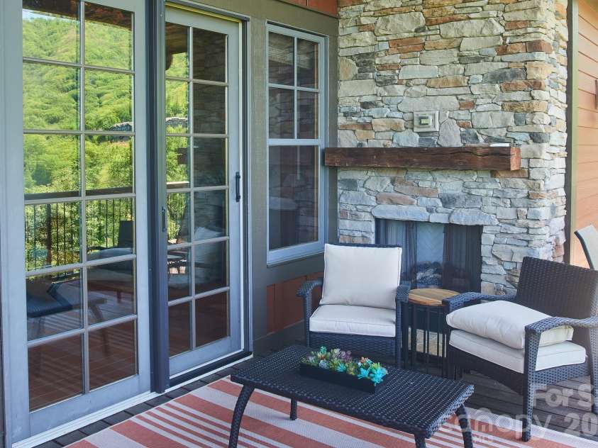 427 Spring Rock Road, Burnsville, NC 28714.  MLS# CAR4379071, YatesRealty ID 27075. Main-level - Cvd Deck with Gas-log FP