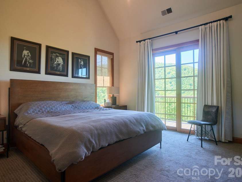 427 Spring Rock Road, Burnsville, NC 28714.  MLS# CAR4379071, YatesRealty ID 27075. Primary Bedroom with direct access to Cvd Deck