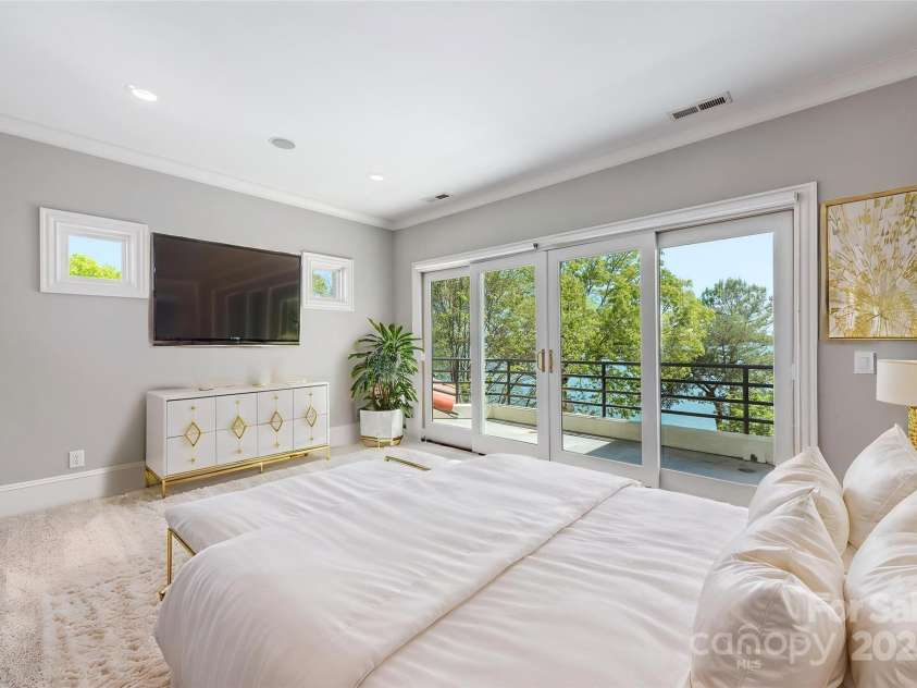 102 Eastham Court, Mooresville, NC 28117.  MLS# CAR4247937, YatesRealty ID 27092. Bedroom 4 with ensuite and gorgeous views of the lake Virtually staged 