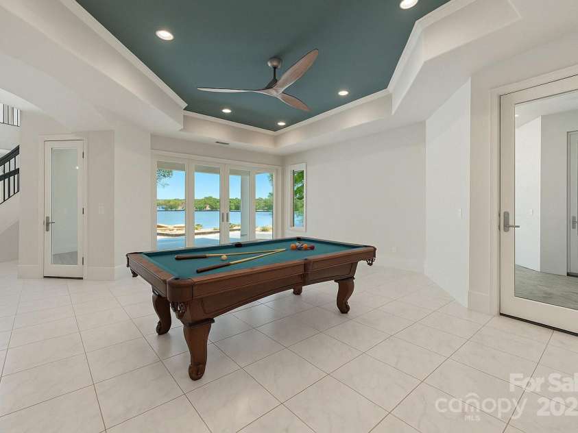 102 Eastham Court, Mooresville, NC 28117.  MLS# CAR4247937, YatesRealty ID 27092. Entertainment room with virtually staged pool table room near indoor and outdoor kitchen area