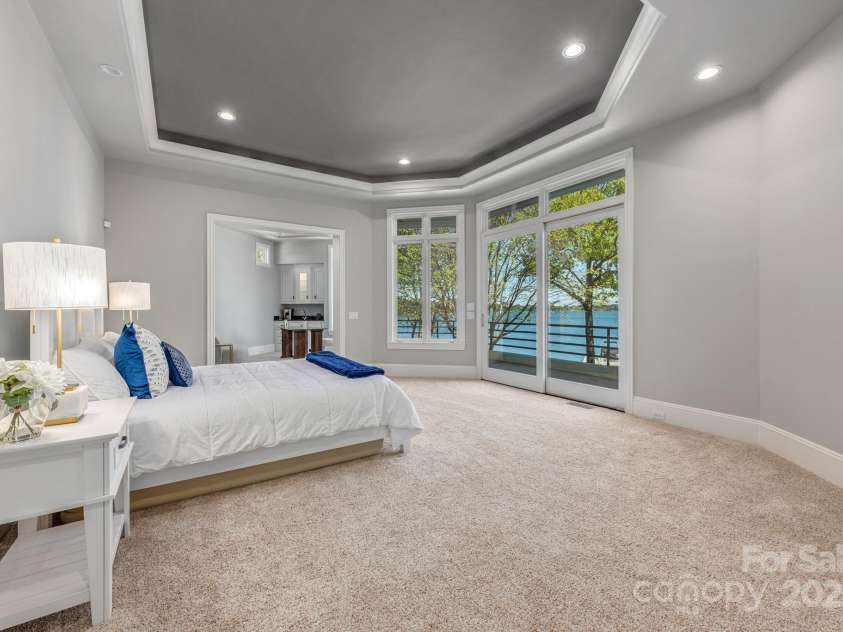 102 Eastham Court, Mooresville, NC 28117.  MLS# CAR4247937, YatesRealty ID 27092. Primary Bedroom with gorgeous lake views and balcony access