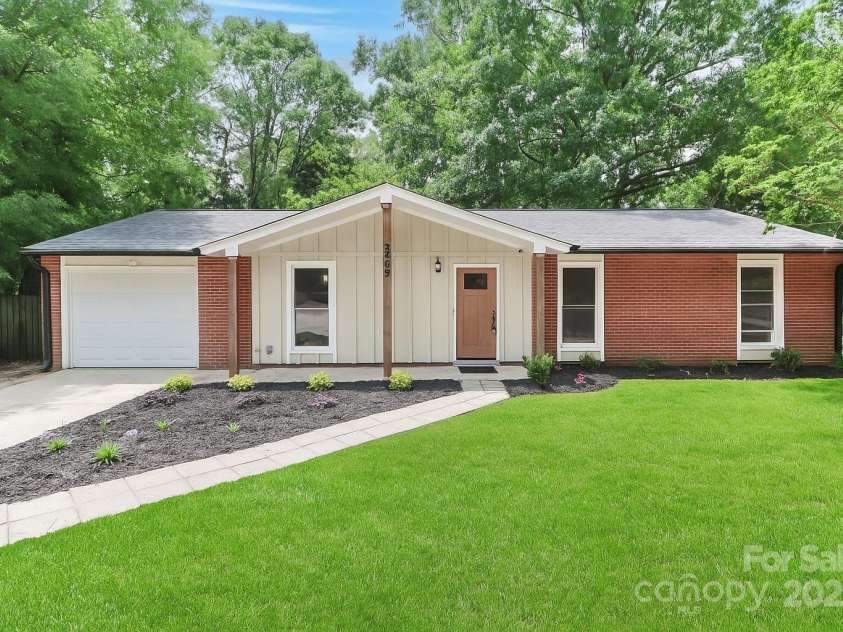 6409 Pineburr Court, Charlotte, NC 28211.  MLS# CAR4282075, YatesRealty ID 27100. Grass in photo is Ai generated.  Lawn has grass seed planted.