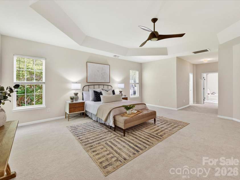 4179 Buckingham Drive, Fort Mill, SC 29707.  MLS# CAR4373781, YatesRealty ID 27110. Expansive primary suite featuring a tray ceiling, abundant natural light, and generous space for a sitting area, creating a serene and luxurious retreat.