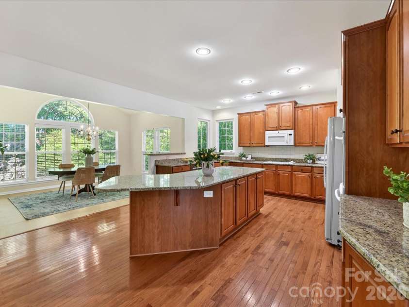 4179 Buckingham Drive, Fort Mill, SC 29707.  MLS# CAR4373781, YatesRealty ID 27110. Spacious chef’s kitchen featuring granite countertops, oversized island with seating, abundant cabinetry, and seamless flow to the breakfast area and main living spaces.