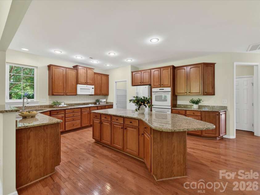 4179 Buckingham Drive, Fort Mill, SC 29707.  MLS# CAR4373781, YatesRealty ID 27110. Spacious chef’s kitchen featuring granite countertops, oversized island with seating, abundant cabinetry, and seamless flow to the breakfast area and main living spaces.