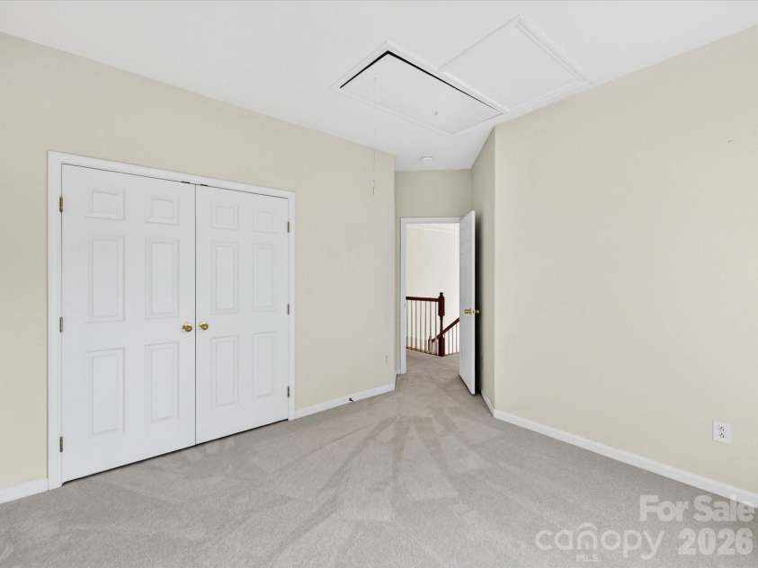 4179 Buckingham Drive, Fort Mill, SC 29707.  MLS# CAR4373781, YatesRealty ID 27110. Spacious third bedroom with large windows, ample closet space, and soft natural light creates a comfortable and inviting retreat.