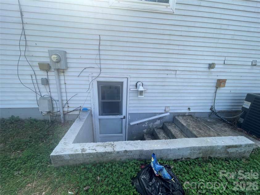 1221 Farmfield Lane, Charlotte, NC 28213.  MLS# CAR4351416, YatesRealty ID 27115. Exterior steps to utility room