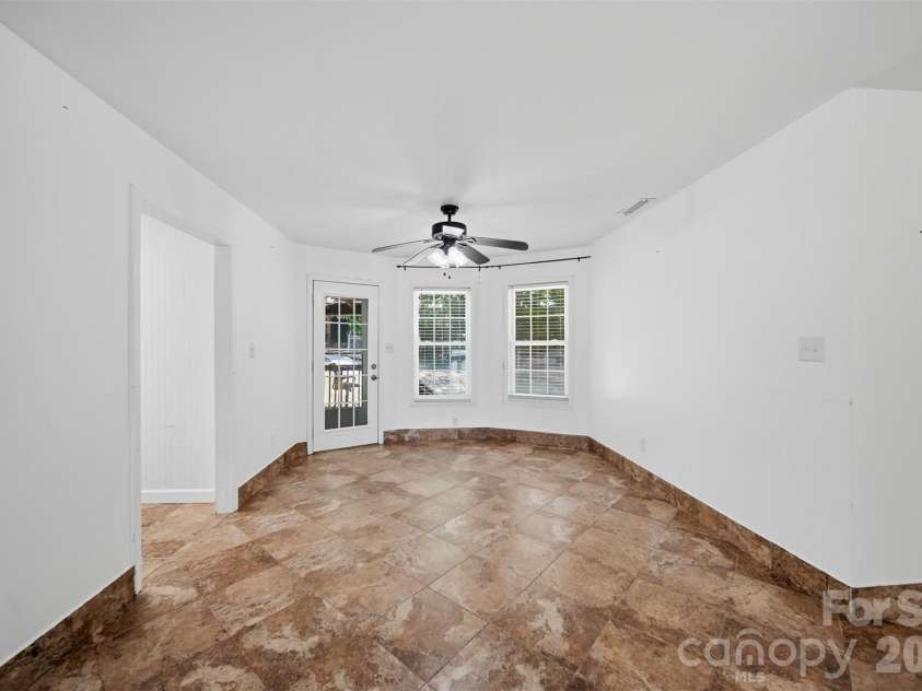 107 Cliffwood Drive, Hudson, NC 28638.  MLS# CAR4384762, YatesRealty ID 27118. Dining room is spacious with kitchen to the left and door to the covered patio and fenced back yard.