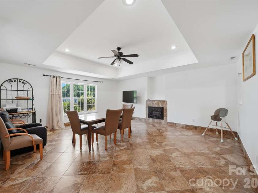 107 Cliffwood Drive, Hudson, NC 28638.  MLS# CAR4384762, YatesRealty ID 27118. Living Room features beautiful tile flooring,tray ceiling and gas log fireplace!
