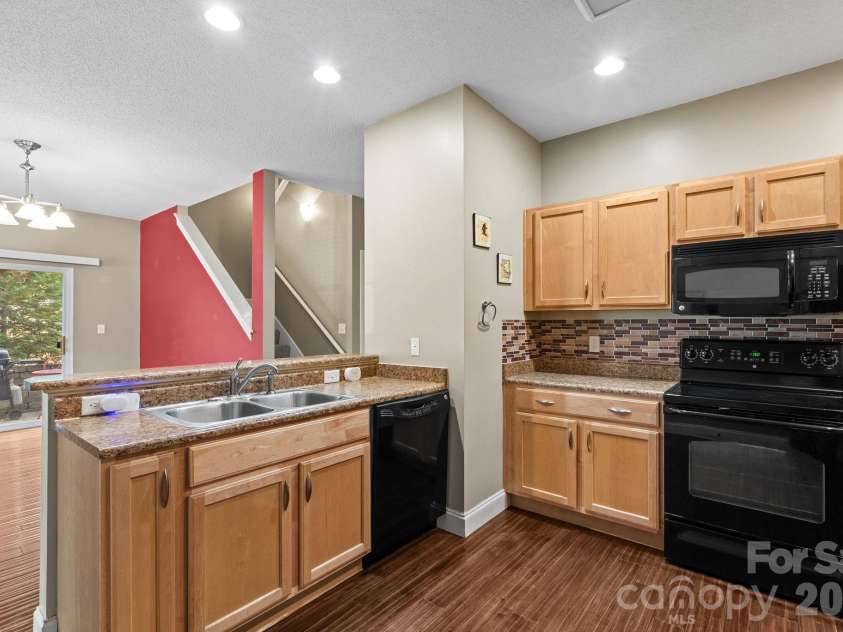 68 Fox Briar Drive, Fletcher, NC 28732.  MLS# CAR4322549, YatesRealty ID 2713. Kitchen looking out at dining room and patio
