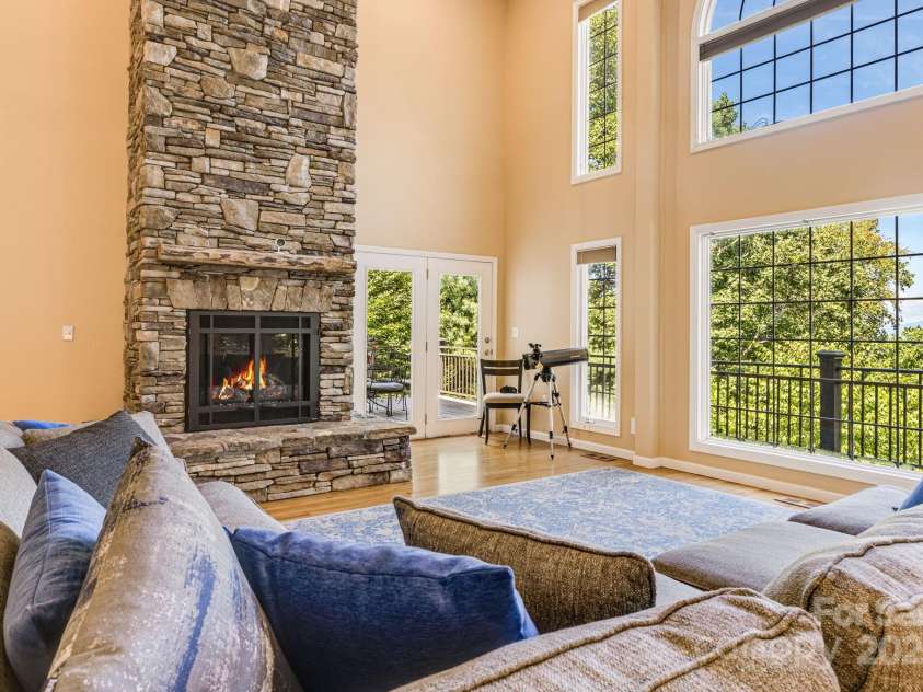201 Cedar Mountain Road, Asheville, NC 28803.  MLS# CAR4281468, YatesRealty ID 27145. Large living room with grand stone fireplace