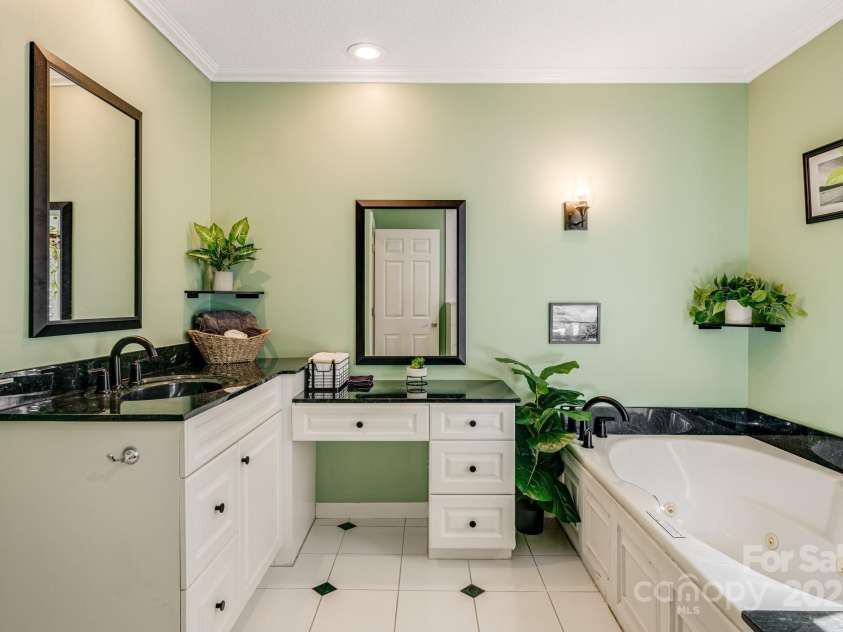 201 Cedar Mountain Road, Asheville, NC 28803.  MLS# CAR4281468, YatesRealty ID 27145. Primary bathroom with shower, tub and vanity