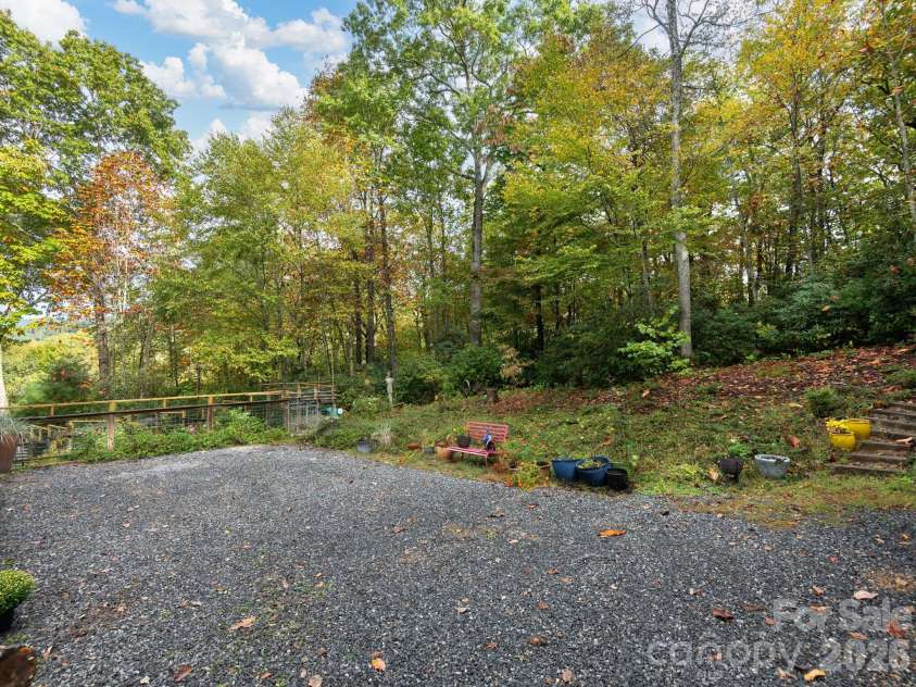 102 Carriage Drive, Fairview, NC 28730.  MLS# CAR4379033, YatesRealty ID 27149. Level Parking Area And Extended Yard Space