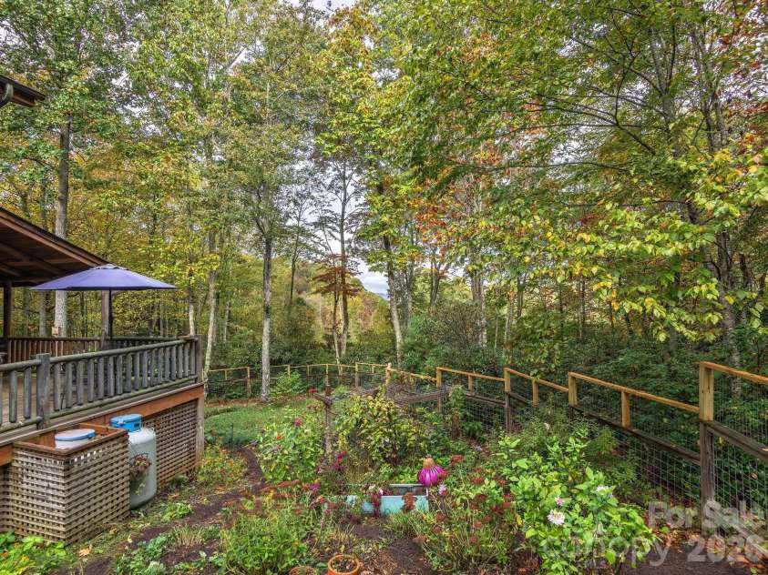 102 Carriage Drive, Fairview, NC 28730.  MLS# CAR4379033, YatesRealty ID 27149. Sweeping Fenced In Yard Framed By Mountains & Trees