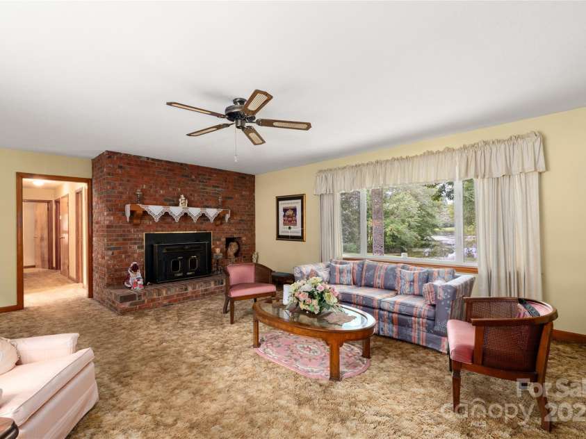 335 Lake Circle Drive, Hendersonville, NC 28792.  MLS# CAR4295963, YatesRealty ID 2715. Living room with wood burning stove