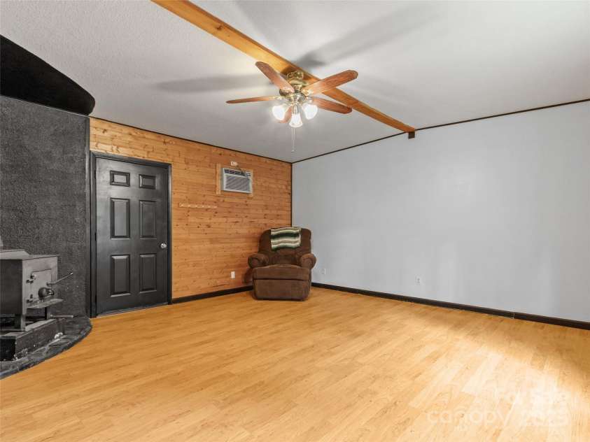 170 Styles Road, Burnsville, NC 28714.  MLS# CAR4283416, YatesRealty ID 27199. Den/Family Room. Door leads to wood shed