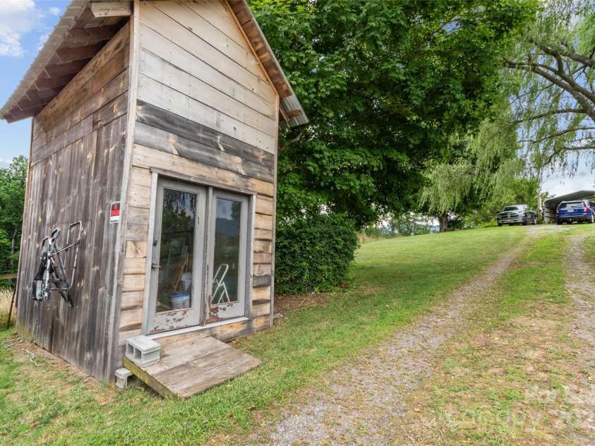 170 Styles Road, Burnsville, NC 28714.  MLS# CAR4283416, YatesRealty ID 27199. Framed out building for possible storage or tiny home