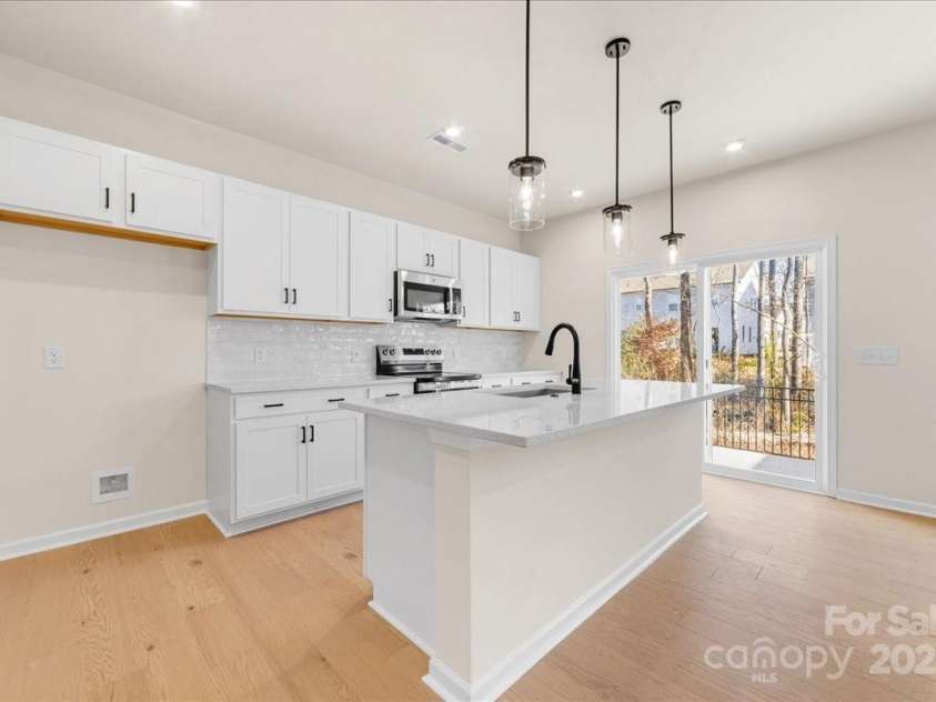 6009 Longar Lane, Charlotte, NC 28269.  MLS# CAR4283710, YatesRealty ID 27219. Crisp White Cabinetry Contrasting with Matte Black Hardware.