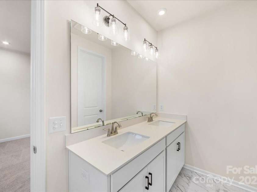 6009 Longar Lane, Charlotte, NC 28269.  MLS# CAR4283710, YatesRealty ID 27219. Dual Vanity with Functional Storage at Primary Suite.