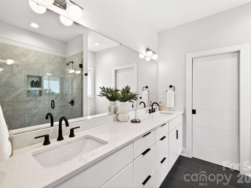 5044 Double Lakes Drive, Charlotte, NC 28212.  MLS# CAR4381424, YatesRealty ID 27220. Ensuite bath with dual sinks and oversized shower with glass doors.