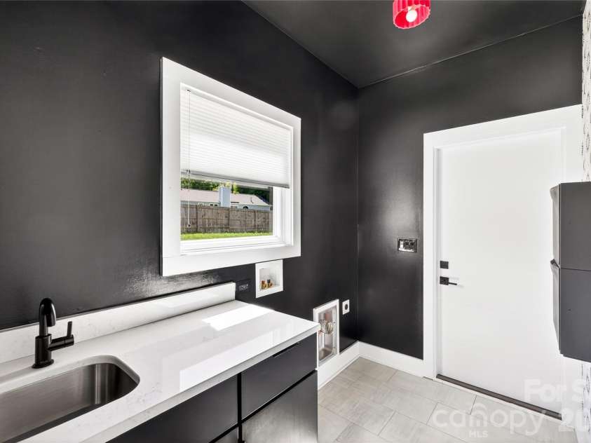 5044 Double Lakes Drive, Charlotte, NC 28212.  MLS# CAR4381424, YatesRealty ID 27220. Main level laundry with sink and cabinet.