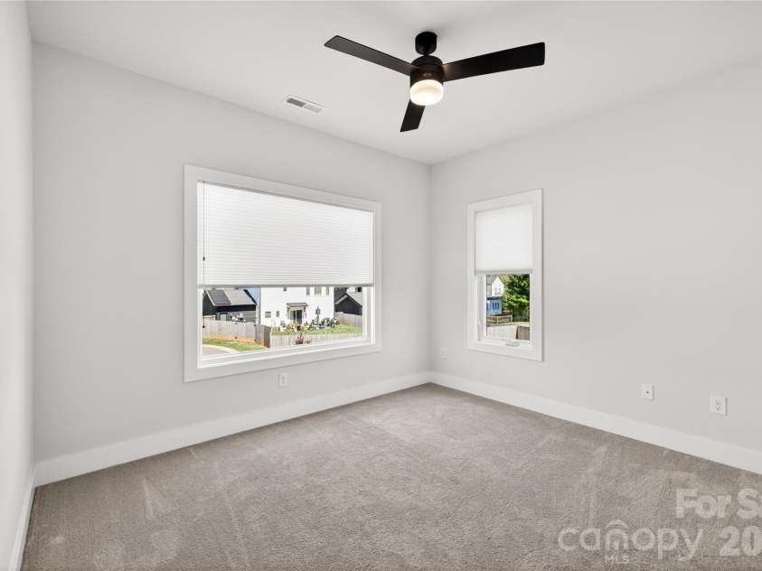 5044 Double Lakes Drive, Charlotte, NC 28212.  MLS# CAR4381424, YatesRealty ID 27220. Secondary bedroom with ceiling fan.