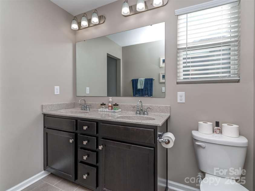 975 Bunker Trace, Rock Hill, SC 29730.  MLS# CAR4322751, YatesRealty ID 27232. Primary bathroom with dual vanity, tile flooring tub & shower combo.
