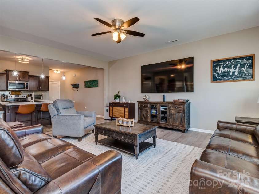 975 Bunker Trace, Rock Hill, SC 29730.  MLS# CAR4322751, YatesRealty ID 27232. The large great room is open to the kitchen and features luxury vinyl plank flooring.