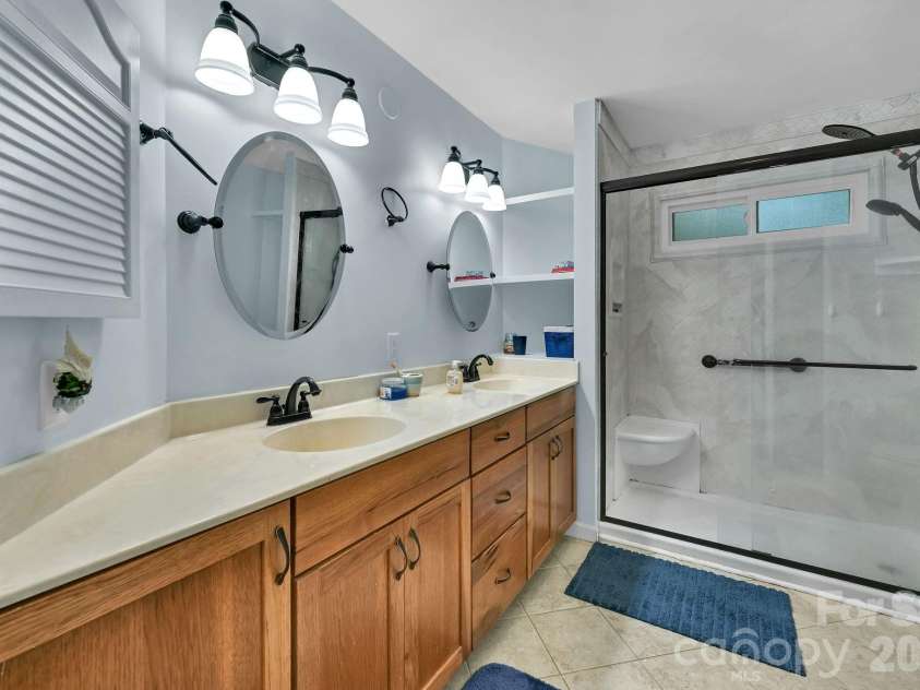 31 St Andrews Drive, Etowah, NC 28729.  MLS# CAR4379830, YatesRealty ID 27240. Primary Bathroom has Double Sink Vanity, Linen Closet & Large Shower