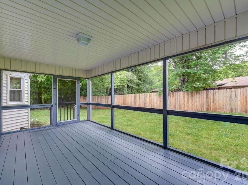 31 St Andrews Drive, Etowah, NC 28729.  MLS# CAR4379830, YatesRealty ID 27240. Screened Back Deck Actual View