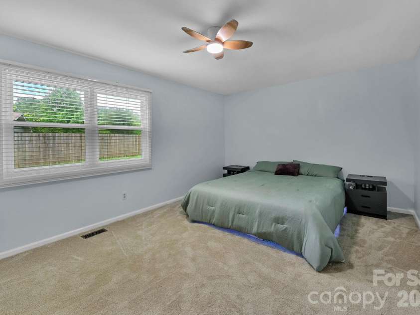 31 St Andrews Drive, Etowah, NC 28729.  MLS# CAR4379830, YatesRealty ID 27240. Spacious Primary Bedroom with Walk-In Closet & New Ceiling Fan