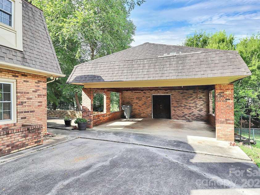4210 Pepperidge Drive, Charlotte, NC 28226.  MLS# CAR4218122, YatesRealty ID 27240. 2-car detached carport with large storage/workroom.