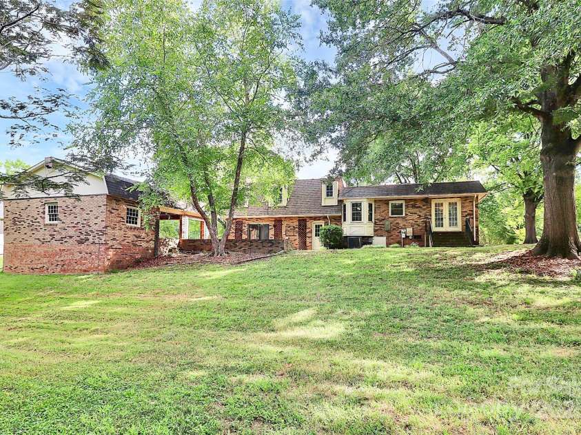 4210 Pepperidge Drive, Charlotte, NC 28226.  MLS# CAR4218122, YatesRealty ID 27240. Rear view of home and carport