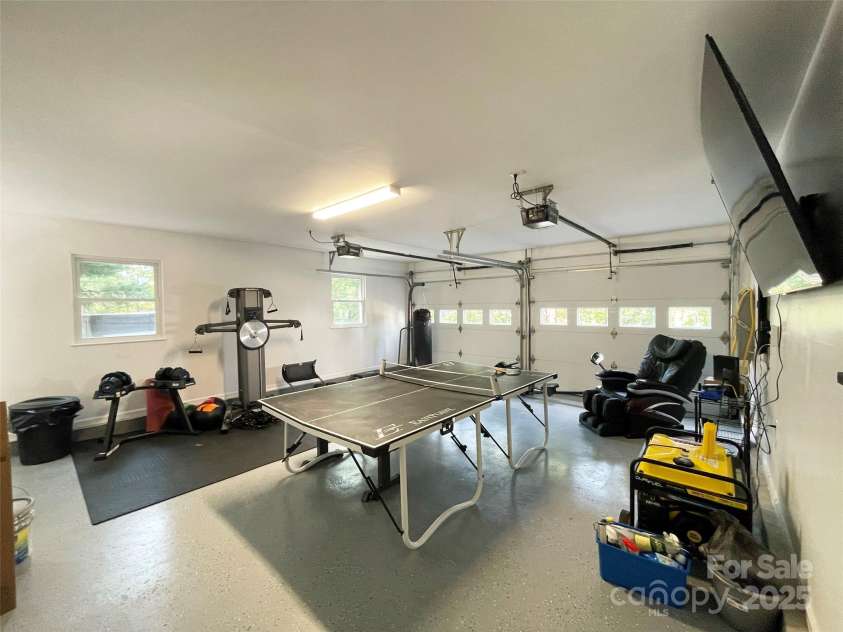 30 Gap Hill Drive, Fletcher, NC 28732.  MLS# CAR4249216, YatesRealty ID 27265. Spacious 2-car garage has new epoxy flooring and is used as a hangout space