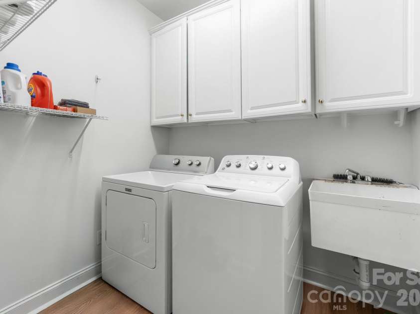 8812 Kingston Forest Drive, Charlotte, NC 28277.  MLS# CAR4374456, YatesRealty ID 27269. Downstairs laundry room with built in cabinets