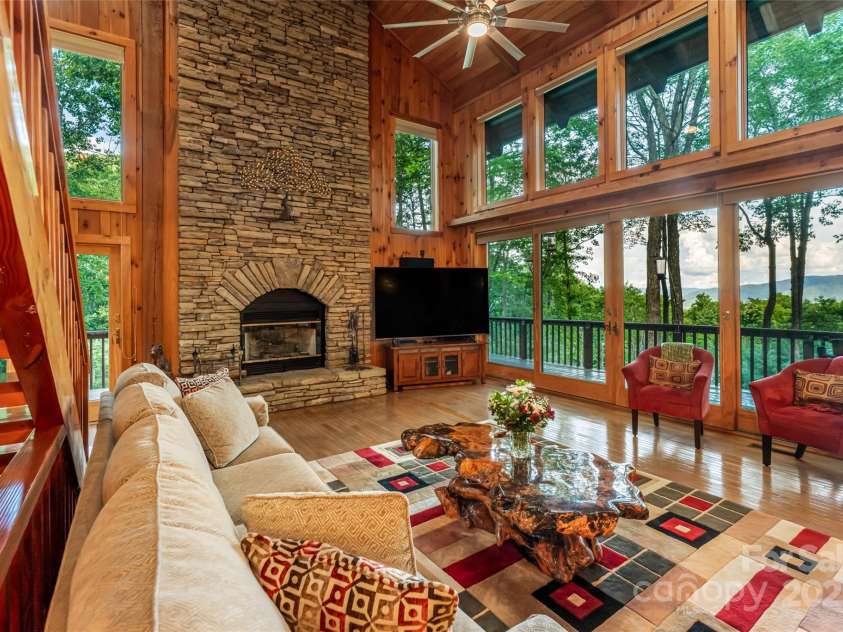 163 Tweetys Knoll, Burnsville, NC 28714.  MLS# CAR4281512, YatesRealty ID 27283. Dramatic floor to ceiling stone fireplace