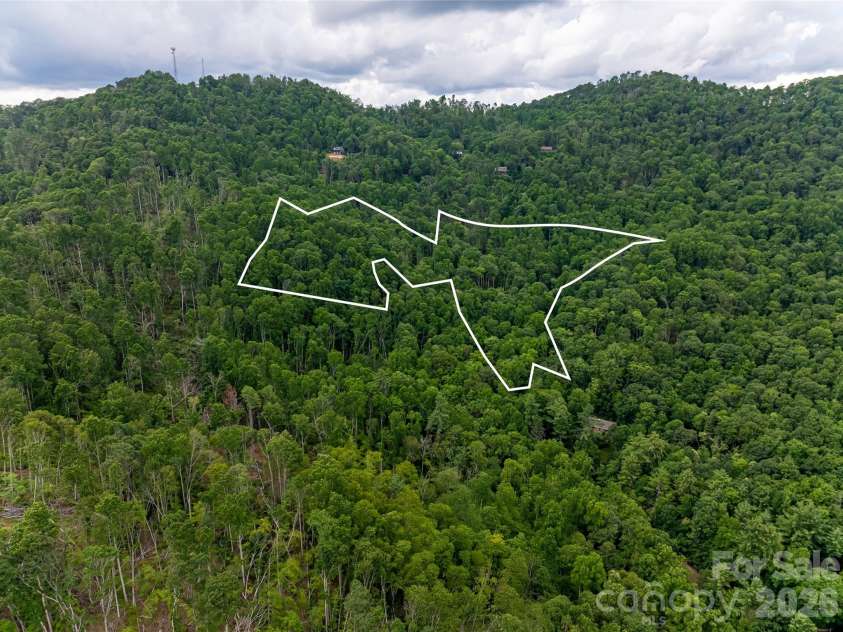 163 Tweetys Knoll, Burnsville, NC 28714.  MLS# CAR4281512, YatesRealty ID 27283. Nearly 12 acres of privacy - only 5 minutes to town square!