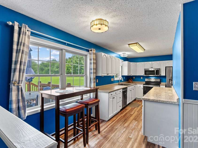 1310 Maple Lee Court, Crouse, NC 28033.  MLS# CAR4278715, YatesRealty ID 27296. Double window in Kitchen overlooks the Rear Deck and brings the outdoors in with tons of light. Note: Main Kitchen countertop is being replaced to match countertop on new sidebar. Laundry Closet is around the corner to t