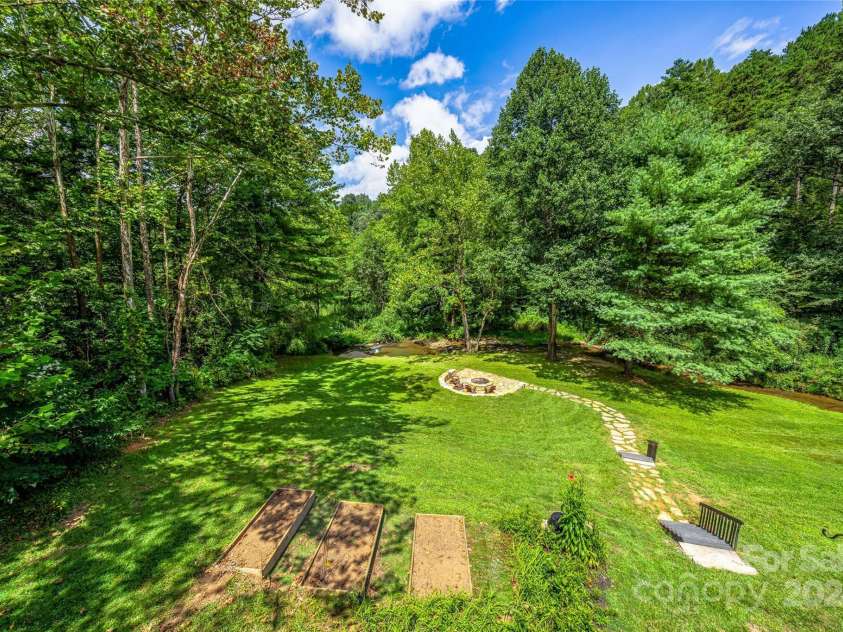 48 Merrell Road, Leicester, NC 28748.  MLS# CAR4172323, YatesRealty ID 2730. Beautiful Back yard with flowing creek