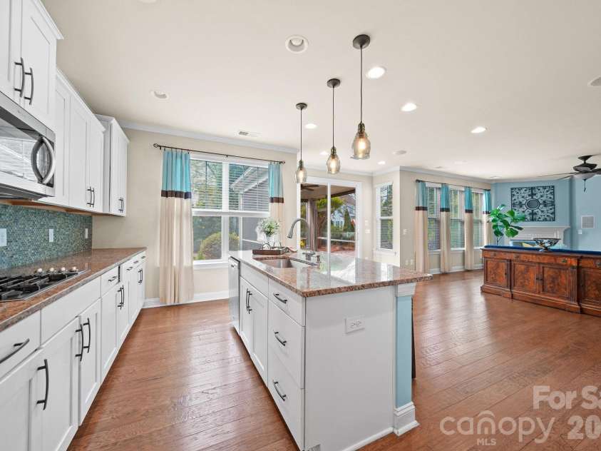 148 Byers Commons Drive, Mooresville, NC 28117.  MLS# CAR4368080, YatesRealty ID 27301. Another view from the kitchen featuring an abundance of windows that fill the space with natural light, with access to the covered, screened in back porch.